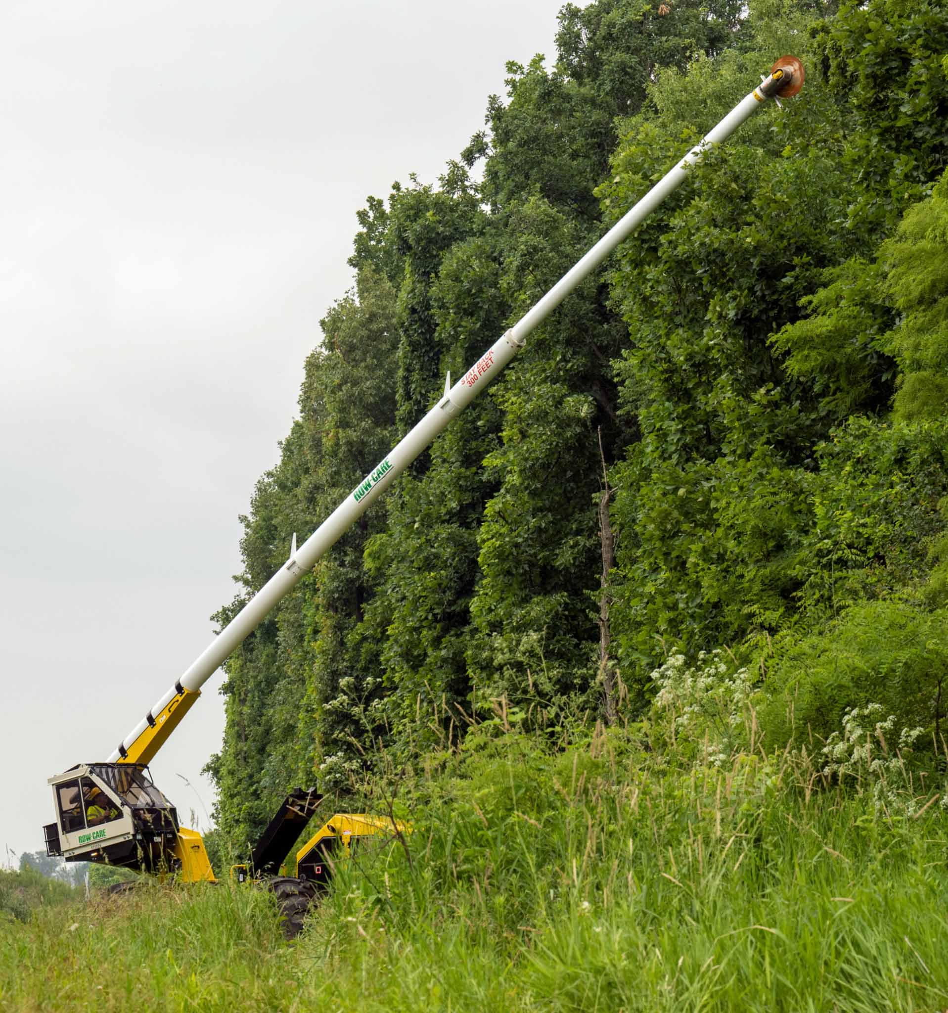 A large telescoping truck trimming a tree