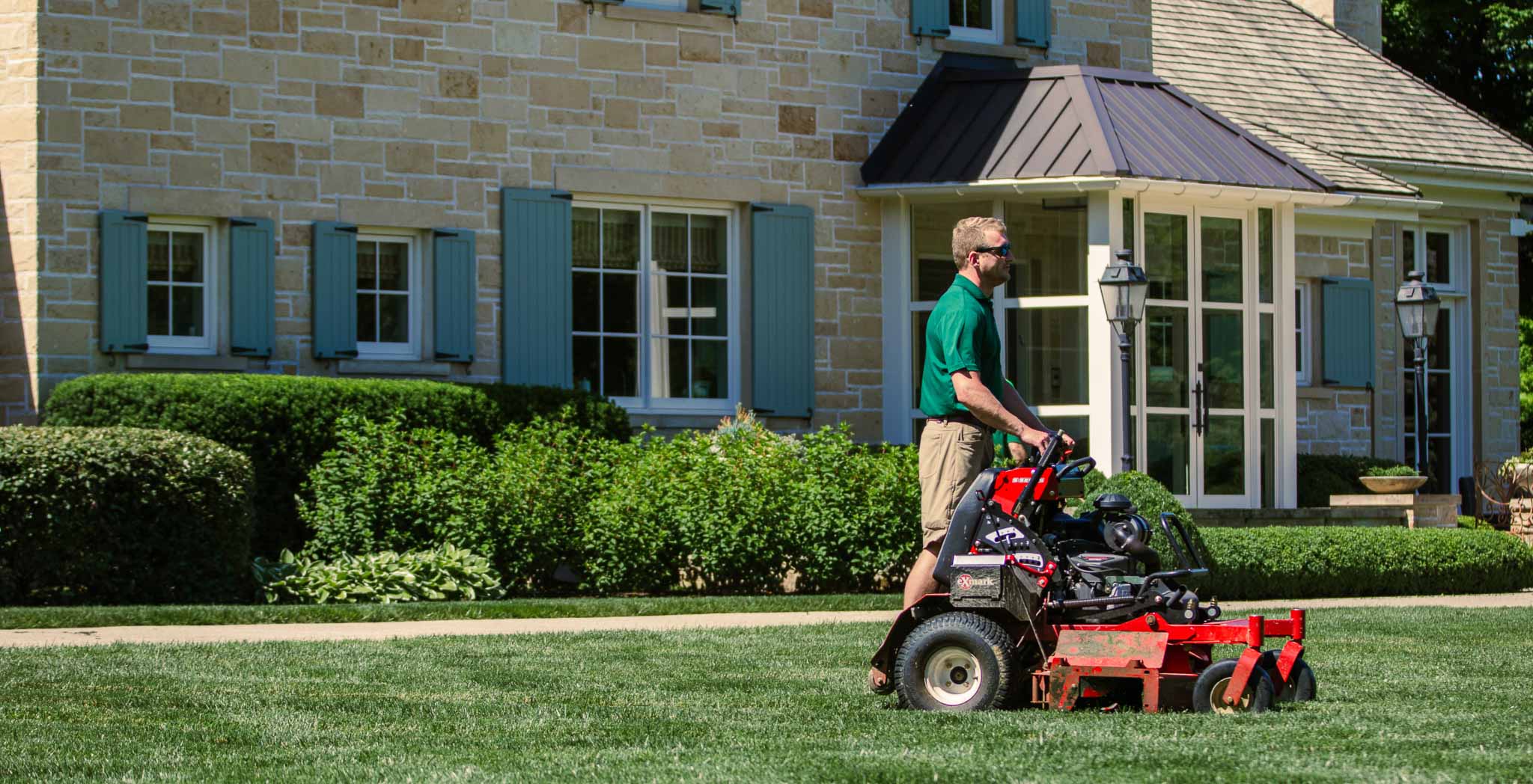 Someone mowing a lawn on a riding lawnmower