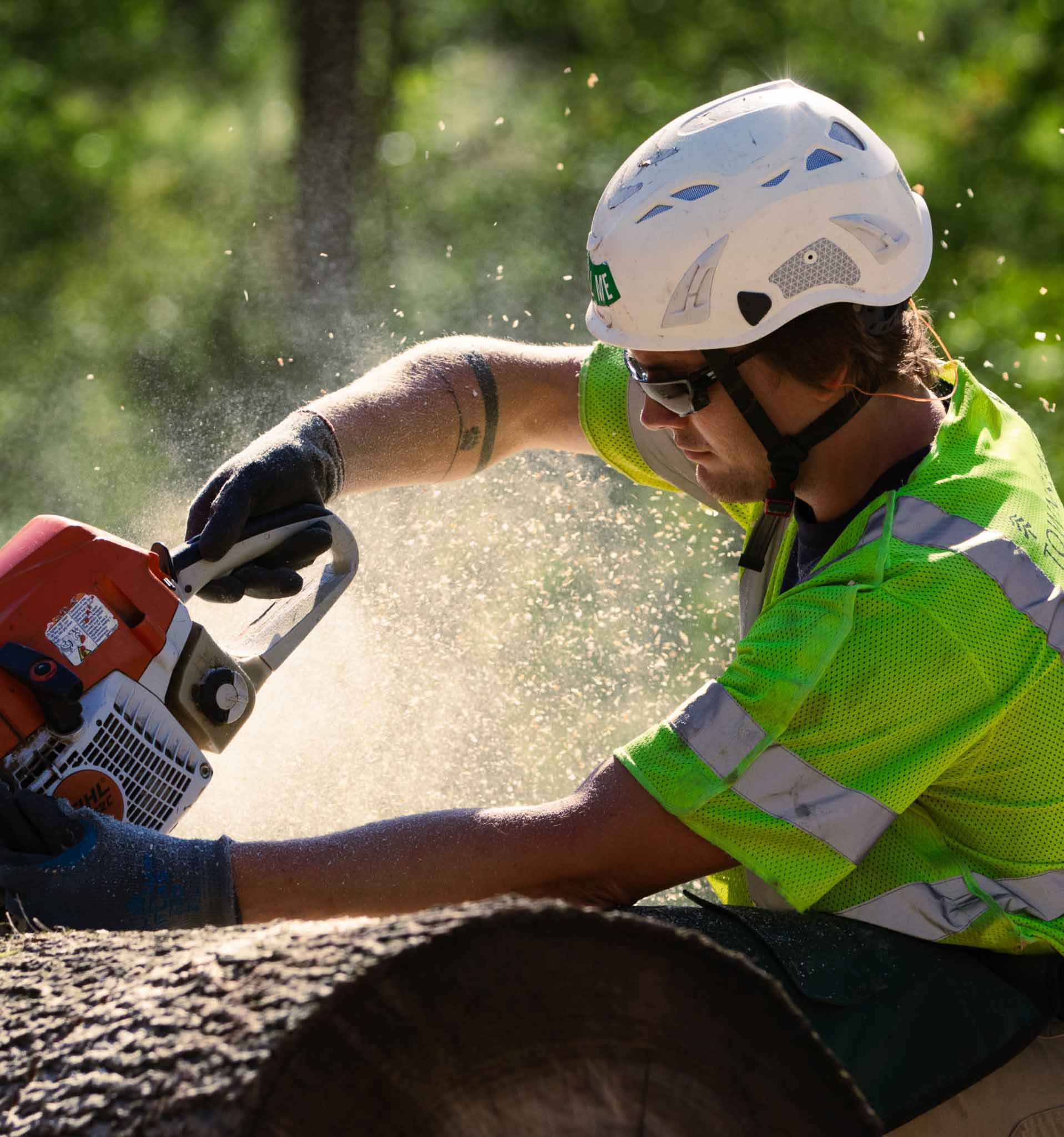 A worker using a chainsaw