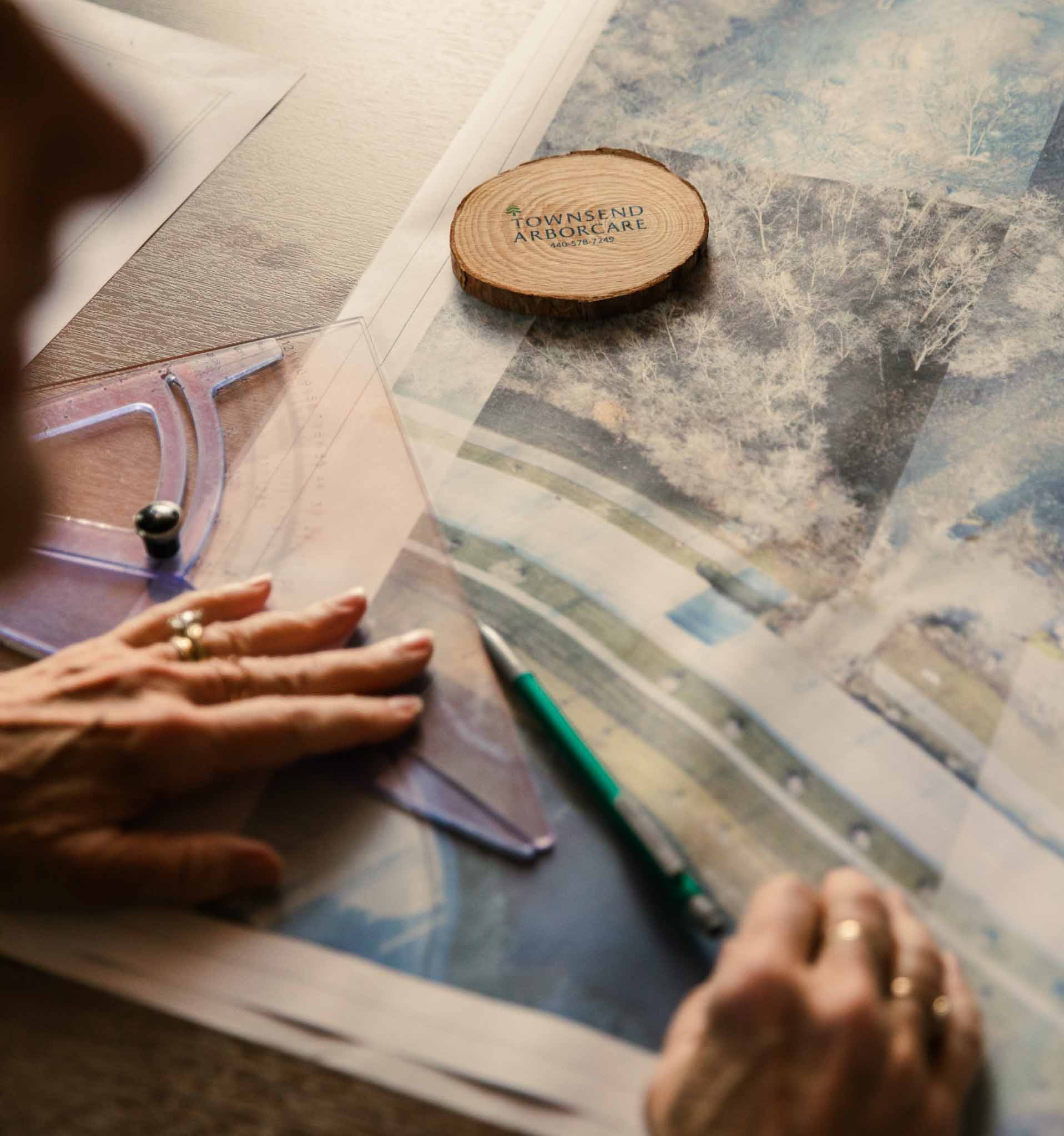 A landscaper measuring on a piece of paper