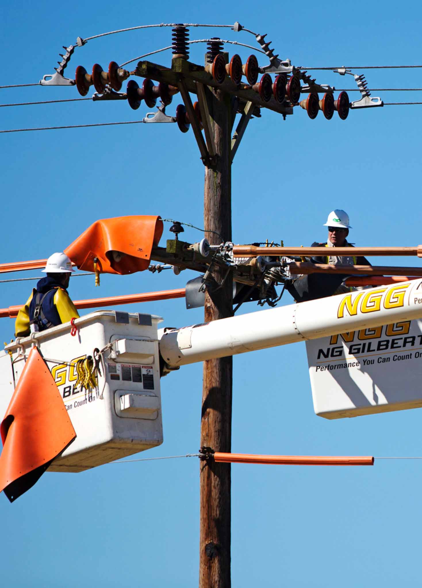 Two workers working on an electrical line