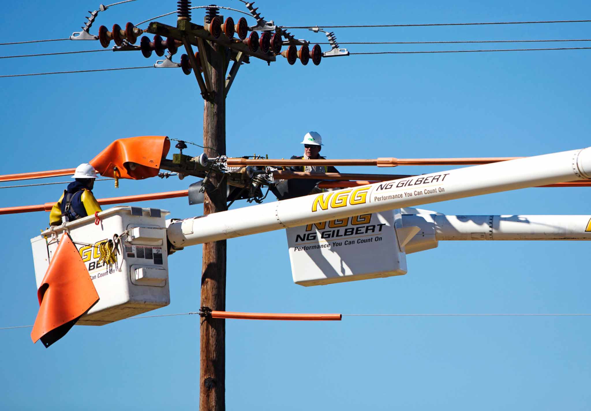 Two workers working on an electrical line