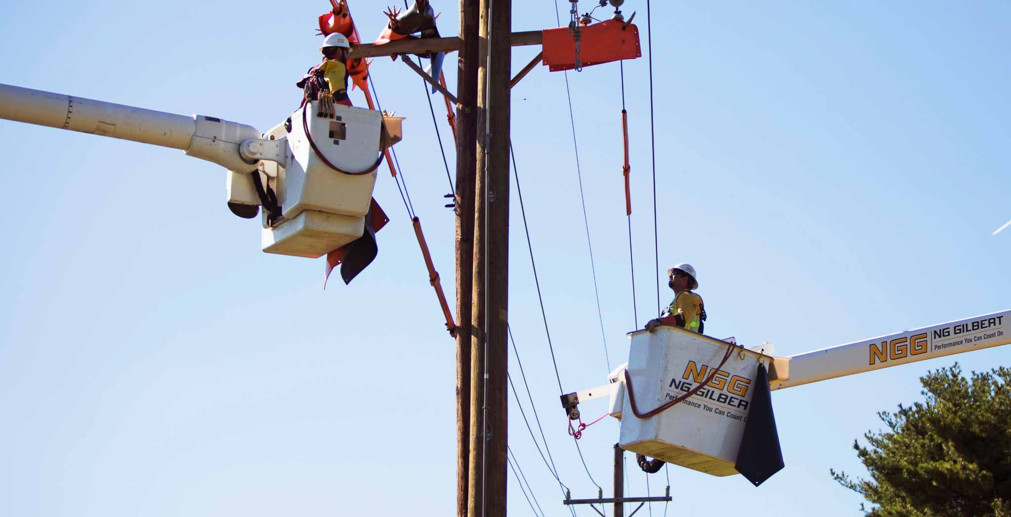 Two workers working on a power line