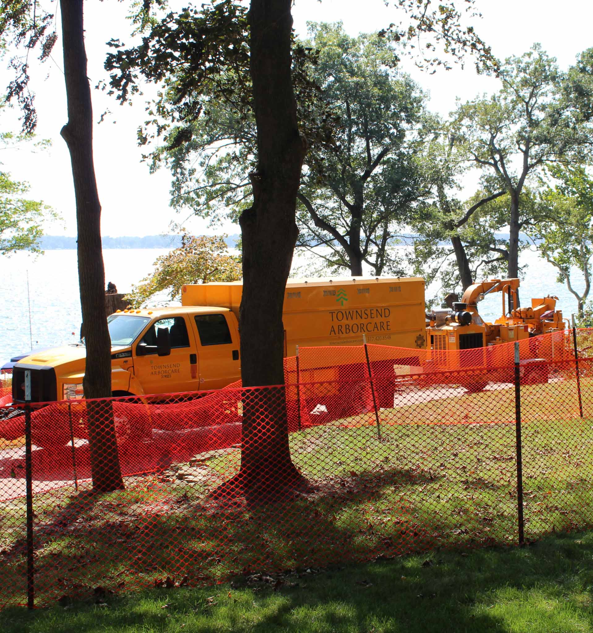 A work truck pulling a wood chipper