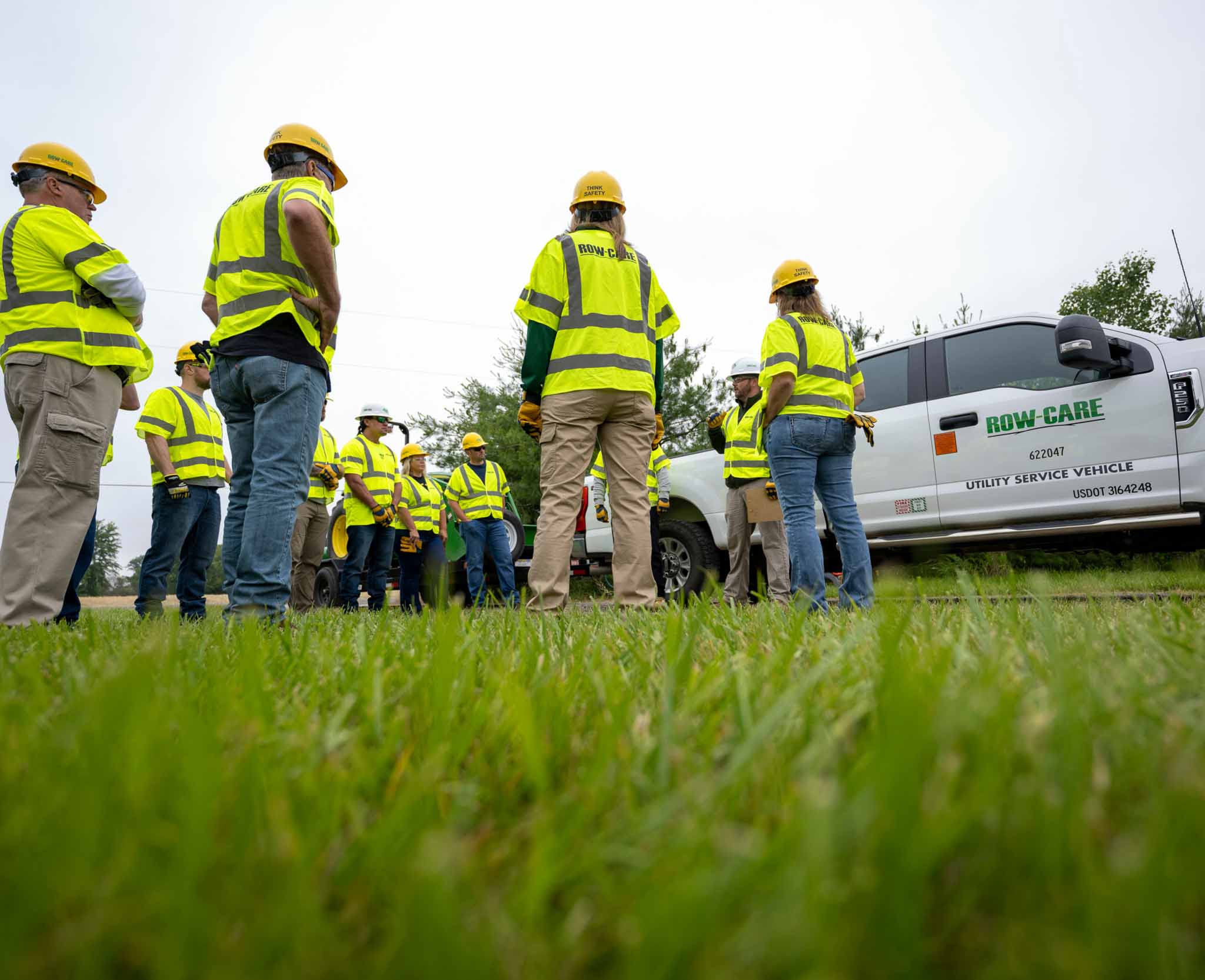 A group of Row-Care employees speaking before a job